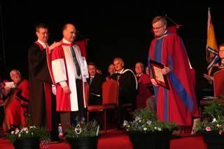 Dr. Glenn Cooke receiving his Honorary Doctor of Science degree from Dr. Eddy Campbell and Dr. Robert MacKinnon.