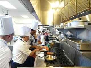 Apprentices Chefs Thierry Chopin, Kifle Hagos and Barry Costa-Pierce cooking salmon lightly in olive oil.